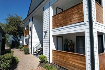 Two story apartment building with wood accents
